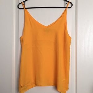 Yellow blouse with spaghetti straps.